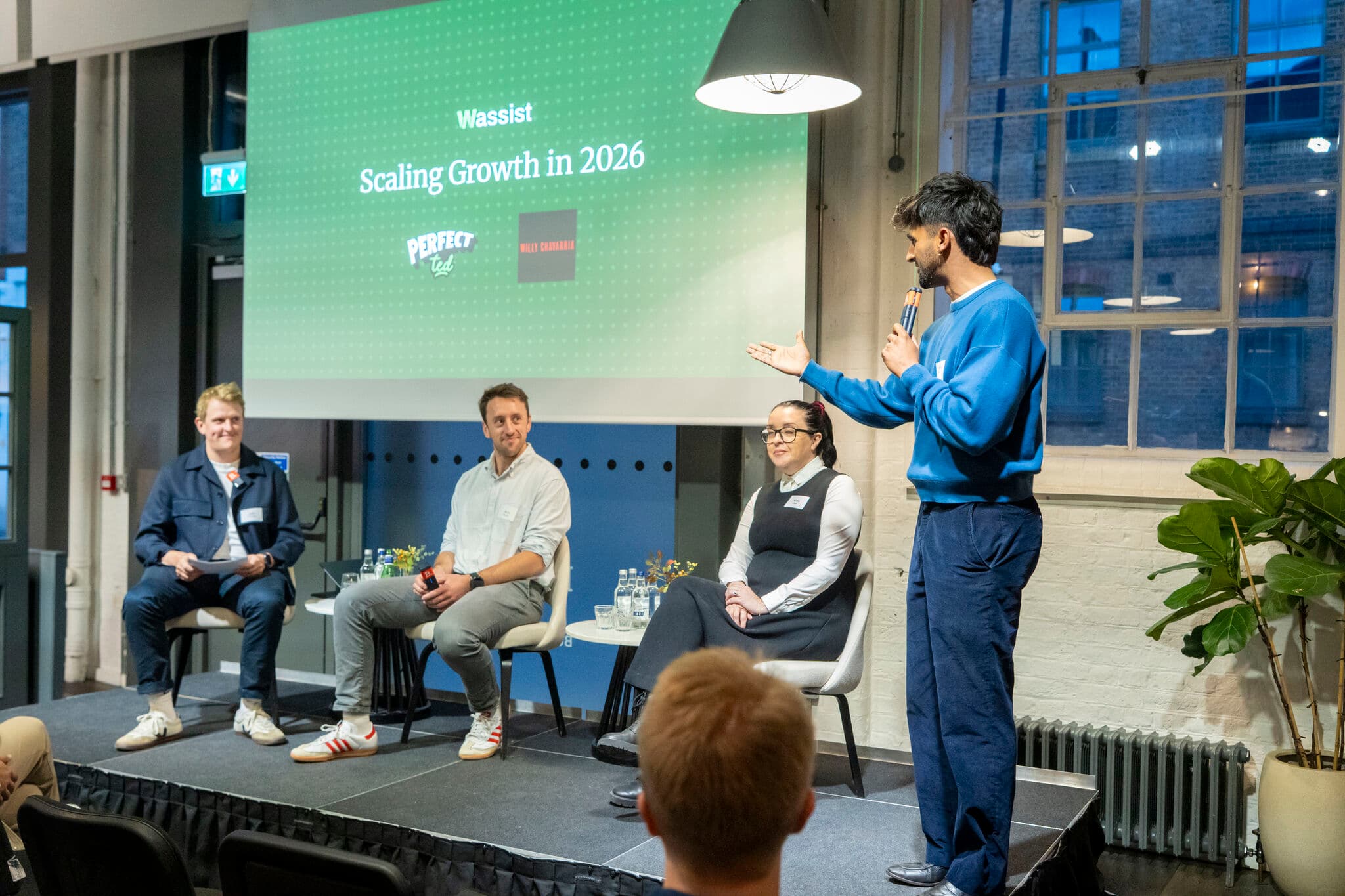 The Scaling Growth in 2026 panel on stage at Balderton Capital in London, with the Wassist, PerfectTed and Willy Chavarria logos on the screen behind them.